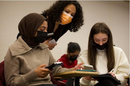 Faculty working with two students