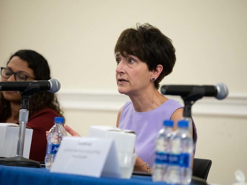 White woman speaking at an event